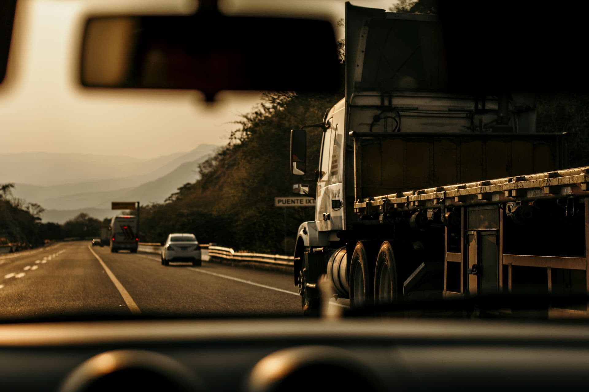 Semi-truck on a highway at golden hour